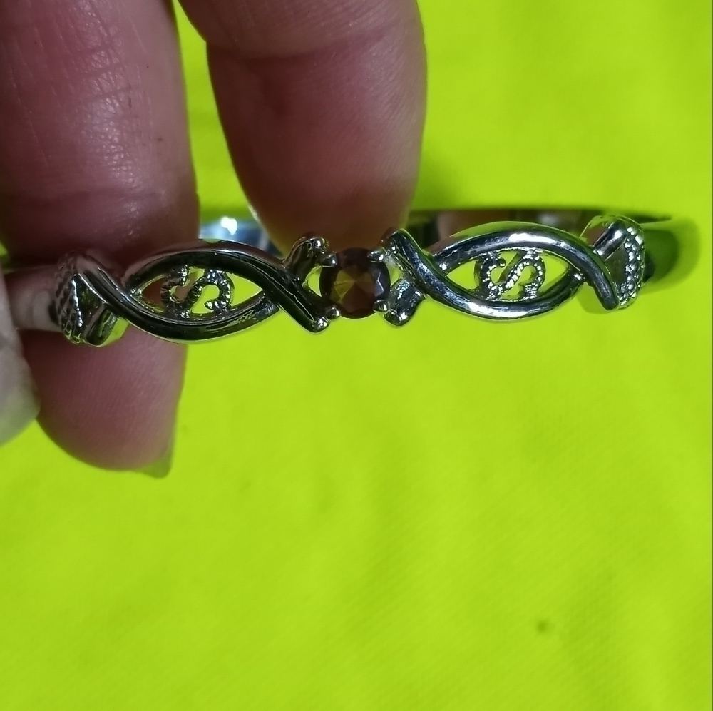 Silvertone hinged pinkish purplish stone bracelet